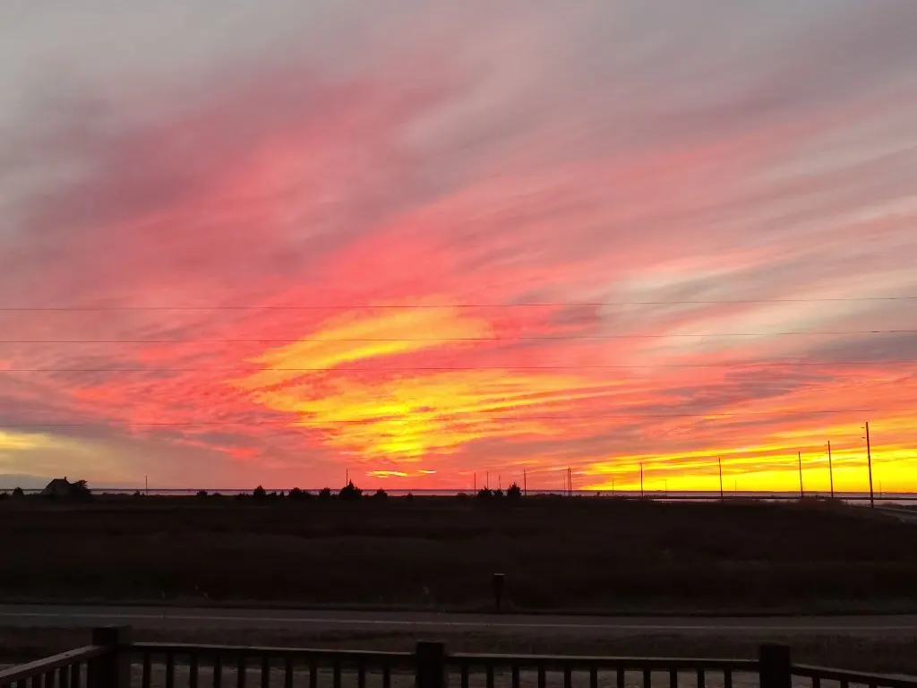 Sunset from the front deck — peaceful golden-hour bay view