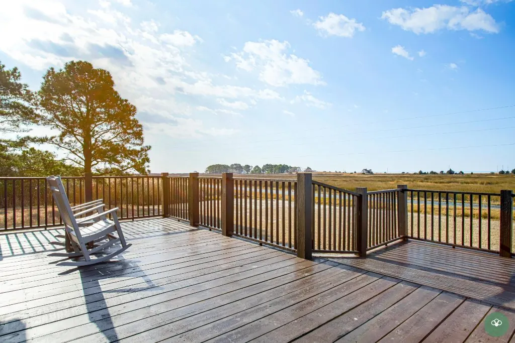 Wellness retreat guests in rocking chairs facing the bay in the morning