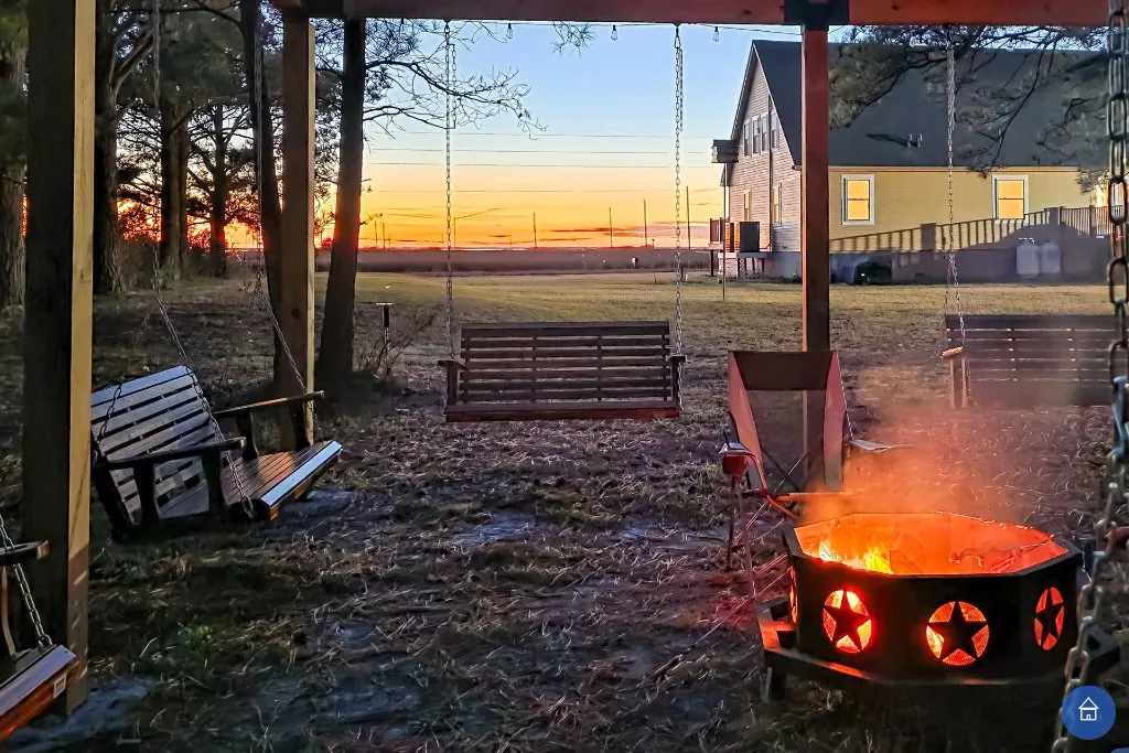 Family around the fire pit at sunset — multigenerational gathering