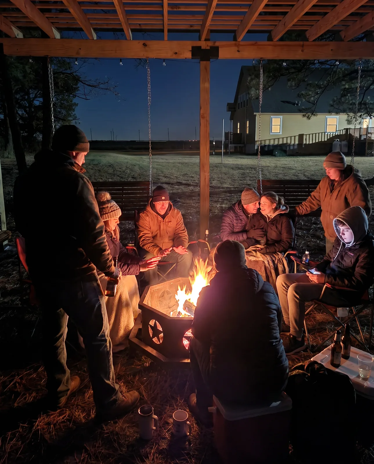 A group around the fire pit in the evening